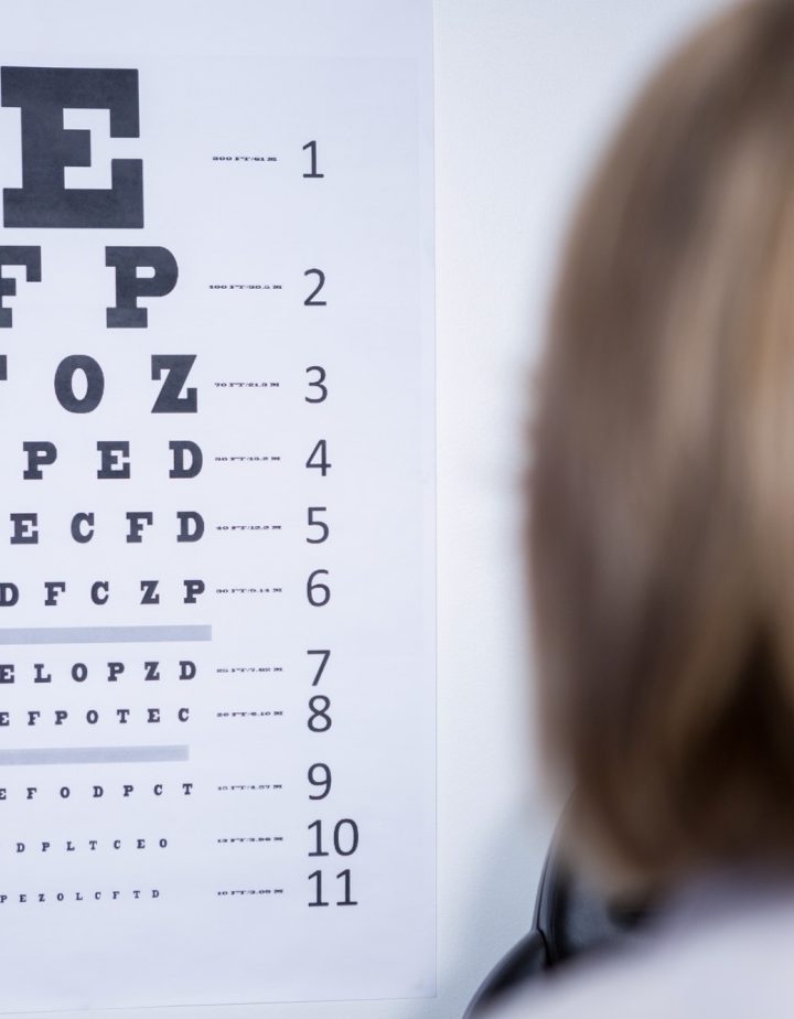 optometrist-looking-at-eye-chart.jpg